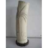 A late 19th century worked ivory tusk with naive carving of an elephant under a palm tree, height 28
