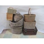 A collection of wicker items including magazine rack, picnic hamper, carry baskets, log bin etc