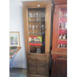 An narrow Ercol display cabinet