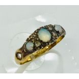 An 18ct gold opal three stone ring with diamond infills