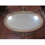 An antique Adam's style oval mirror