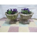 A pair of concrete garden pots