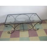 A wrought iron coffee table with glass top