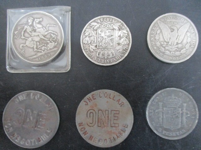 A small collection of coins- Victorian Crown, 1897 Liberty silver dollar, two $1 tokens etc. - Image 2 of 2