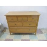 A contemporary oak chest of six drawers