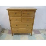 A contemporary oak chest of six drawers