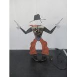 A lamp in the form of a cowboy