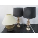 A pair of modern lamps, along with an Islamic brass lamp