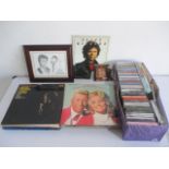 A collection of vinyl records including Dolly Parton, along with a collection of CD's.