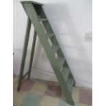 A vintage green painted wooden step ladder