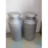 Two vintage milk churns with lids