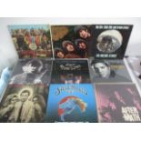 A collection of 12" vinyl records including The Beatles, The Rolling Stones, Jimmy Page, Neil Young,