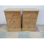 A pair of pine bedside cabinets