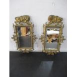 A pair of Victorian gilt brass mirrors decorated with lions fighting a serpent, height 3.6.5cm