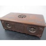 A wooden box with cartwheel design decoration