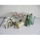 A collection of bottles, glass jars, mugs, enamelled bread bin etc