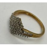 A 9 ct gold dress ring set with diamonds