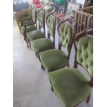 A set of six reproduction button backed dining chairs including two carvers