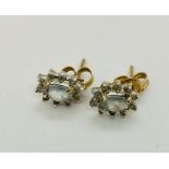 A pair of aquamarine and diamond cluster earrings.