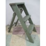 A small vintage wooden green painted step ladder
