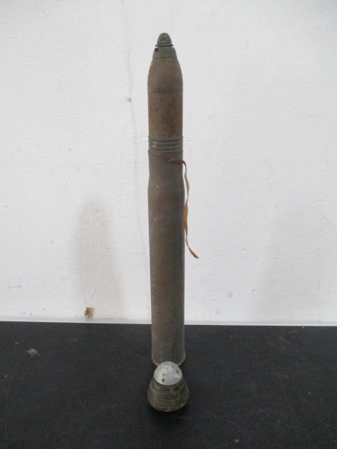 An inert WWI era brass shell with Scovill style fuse and one other fuse