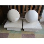 A pair of sandstone balls finials - 1 partially stripped