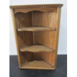 A small oak hanging corner cupboard