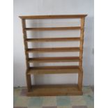 A large freestanding pine bookcase- height 181cm, width 134cm