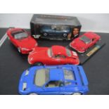 Four Burago model cars along with a boxed "Goldeneye" BMW Z3 Roadster by UT Models