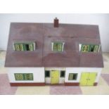 A vintage dolls house along with various furniture