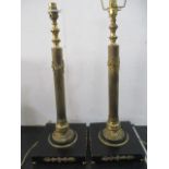 A pair of ebonised and gilt brass Empire style table lamps, 59cm height