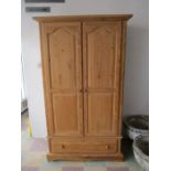 A large pine wardrobe with under drawer - height 197cm, width 107cm, depth 57cm