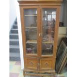 A scumble glazed display cabinet with cupboard under