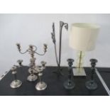 A silver plated candleabra along with various candlesticks, light etc.