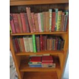 A collection of vintage books including Robin Hood, Robinson Crusoe, Scarlett Pimpernel