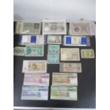 A collection of foreign banknotes along with travellers cheques etc.