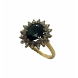 An 18ct gold ring with large central sapphire and diamond edging