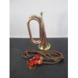 A copper and brass bugle marked Vincent Bach Corp. 7CFL