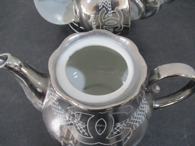 A Chanel porcelain tea set with silver colour glaze all decorated with the Chanel logo on stand- tea - Image 3 of 6