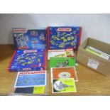 Three boxed Meccano sets along with a box of Meccano instruction booklets.