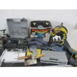 A collection of various power tools and accessories including a Ferm jig saw, belt sander, drill,