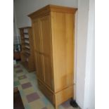 A contemporary oak wardrobe with under drawer
