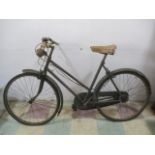 A vintage ladies bicycle with chain guard