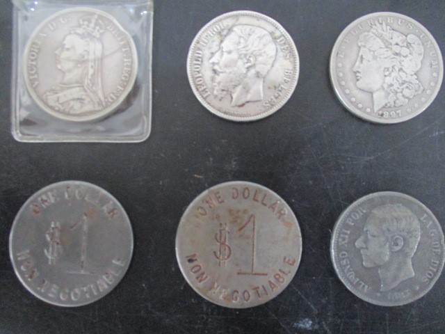 A small collection of coins- Victorian Crown, 1897 Liberty silver dollar, two $1 tokens etc.