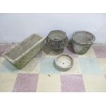 A collection of garden concrete pots, along with one trough