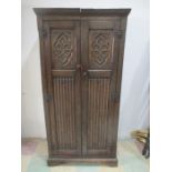 A oak wardrobe with carved decoration