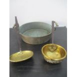 A two handled brass pan, along with a brass skimmer and ladel