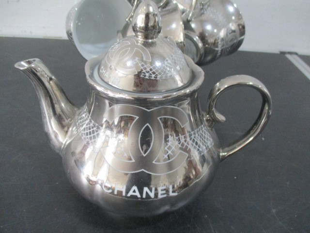 A Chanel porcelain tea set with silver colour glaze all decorated with the Chanel logo on stand- tea - Image 2 of 6