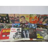 A collection of 12" vinyl records including The Kinks, The Beatles, The Rolling Stones, Cliff