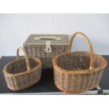 A wicker picnic basket along with two other wicker baskets